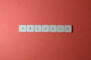 Close-up of letter tiles spelling PRIVACY on a red background, symbolizing data protection.