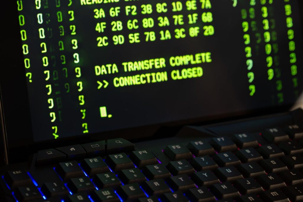 Data transfer complete message displayed on a computer monitor with a keyboard underneath.